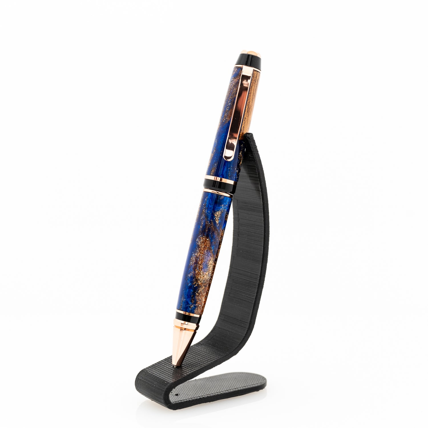 a handmade blue and bronze resin pen with wood and bright copper plating on a black stand