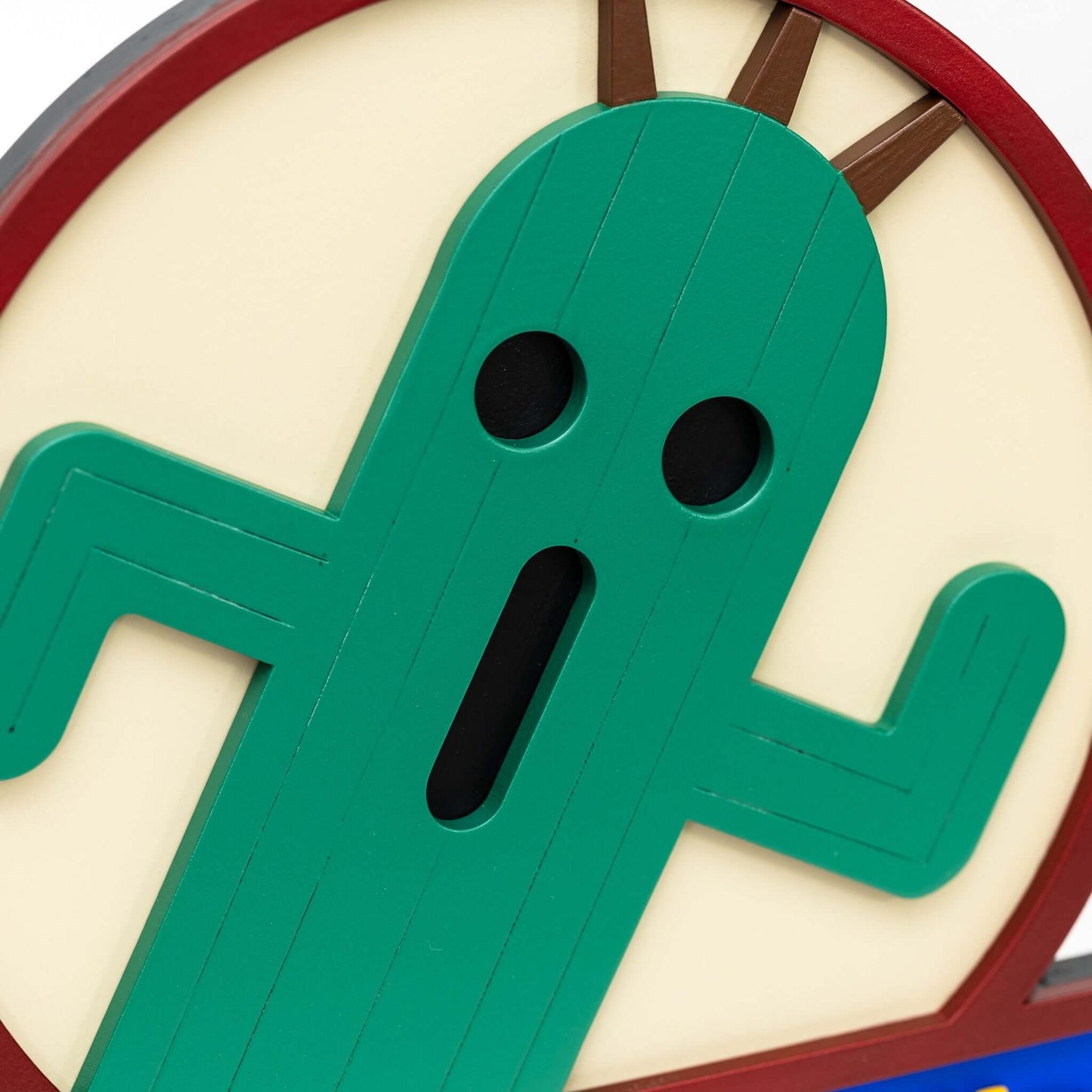 A handmade and hand-painted carved wooden sign featuring a Cactuar from the Final Fantasy series of video games.