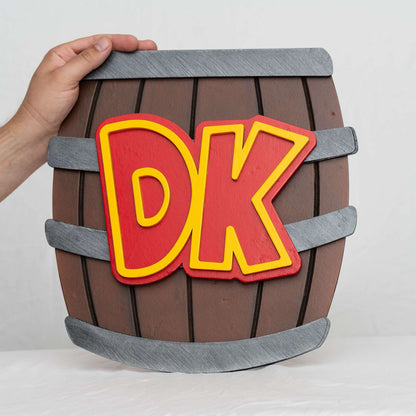 A handmade and hand-painted carved wooden sign featuring the barrel from the Donkey Kong series of Nintendo video games.