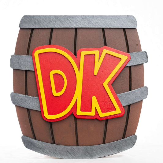 A handmade and hand-painted carved wooden sign featuring the barrel from the Donkey Kong series of Nintendo video games.