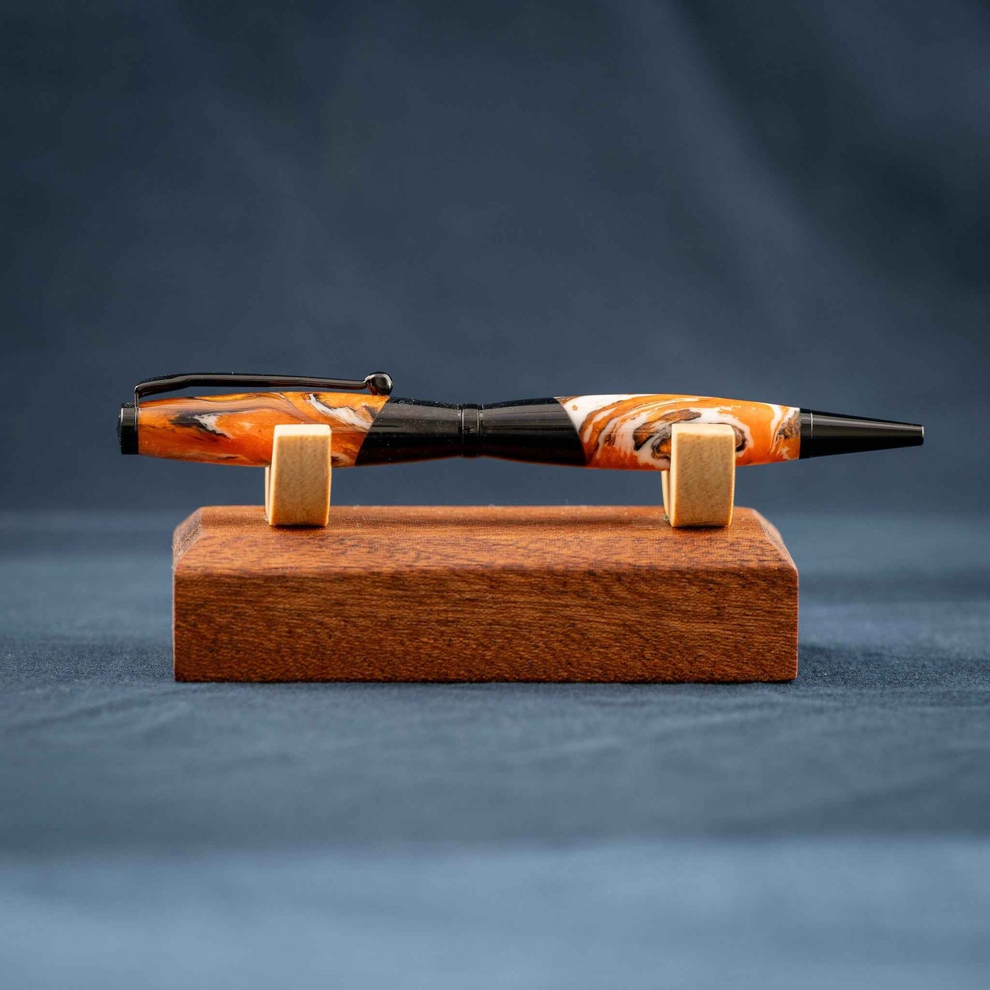 Orange, White, and Black Swirled Resin Twist Pen with Black Center Segment