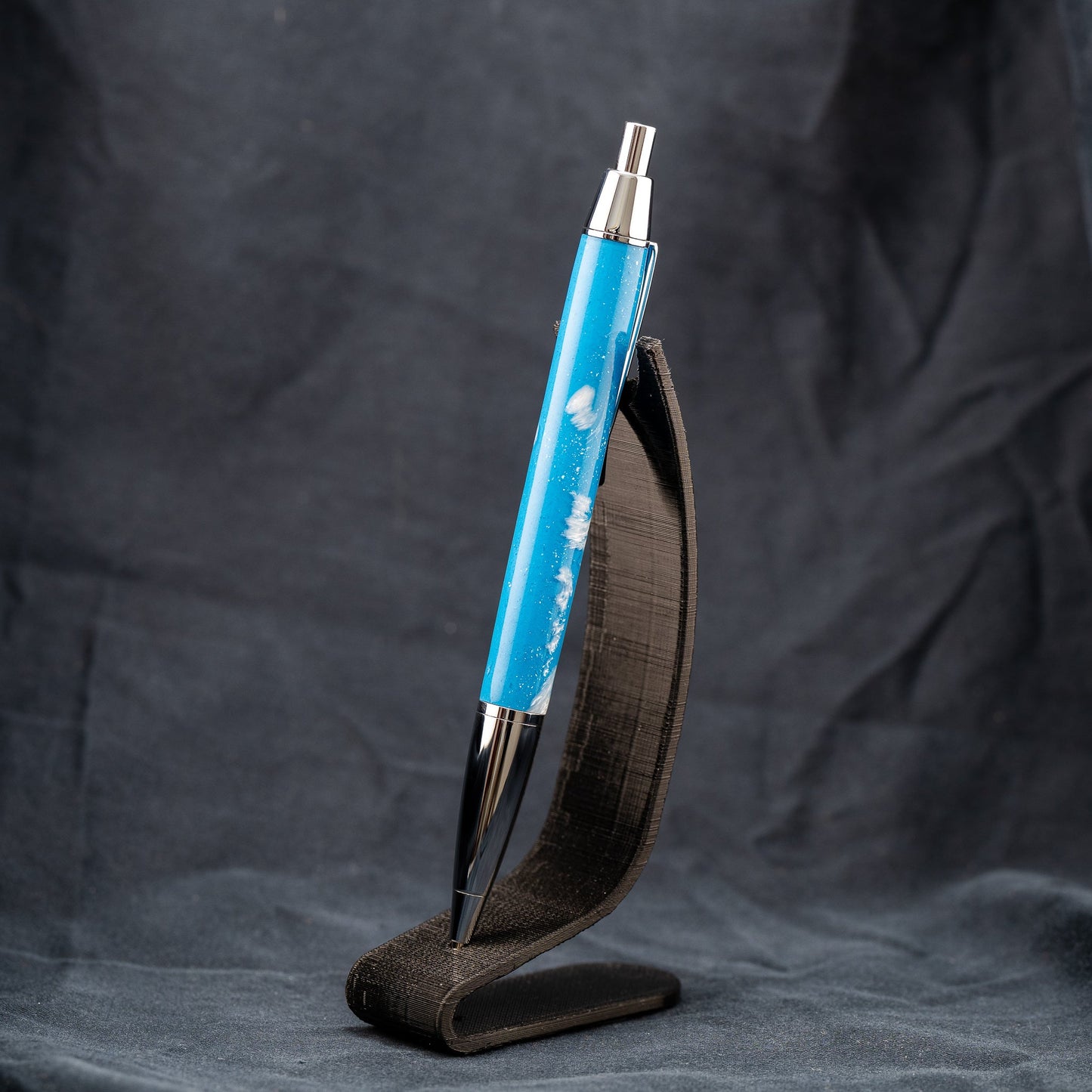 Handmade blue and white resin click ballpoint pen with chrome plating and black ink.