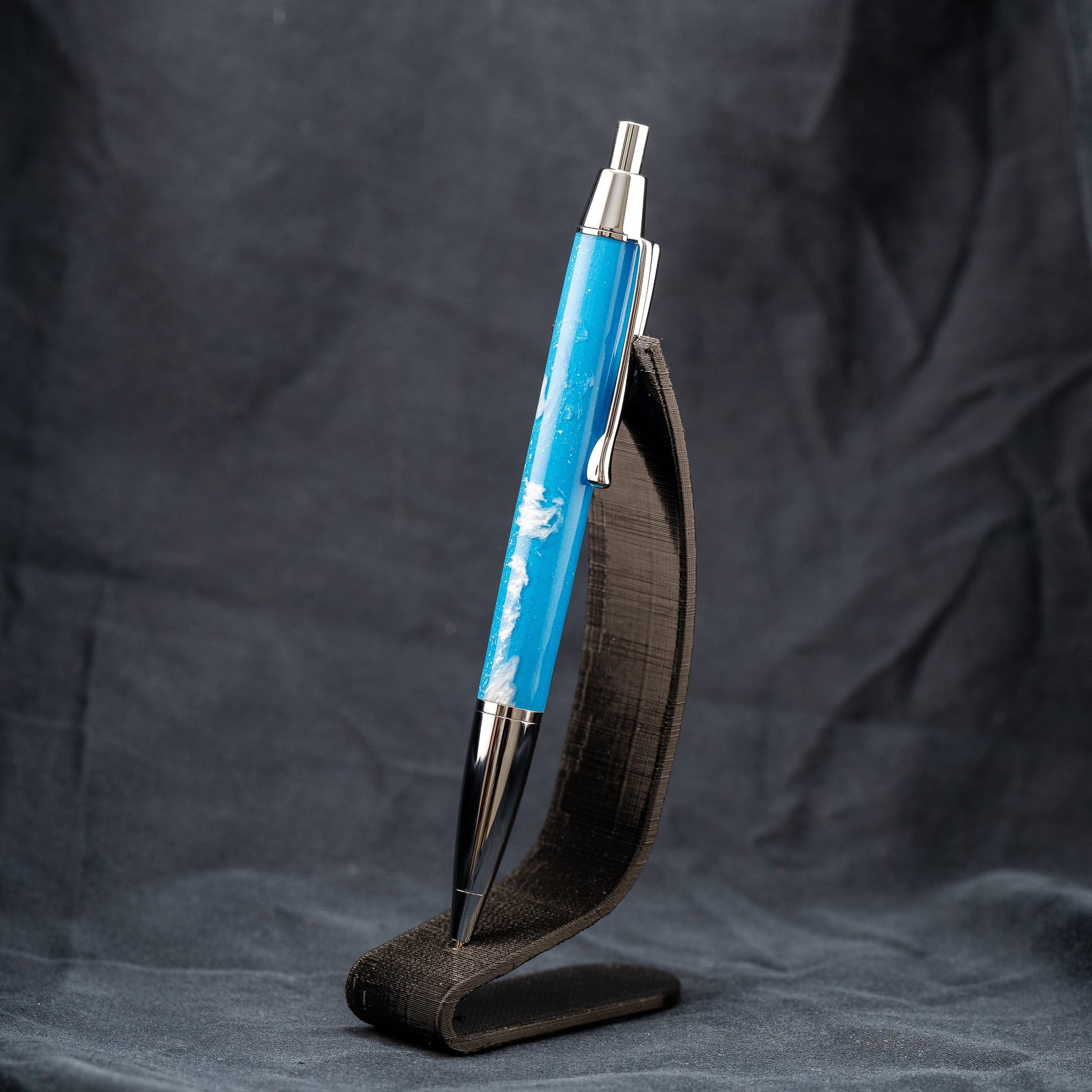 Handmade blue and white resin click ballpoint pen with chrome plating and black ink.