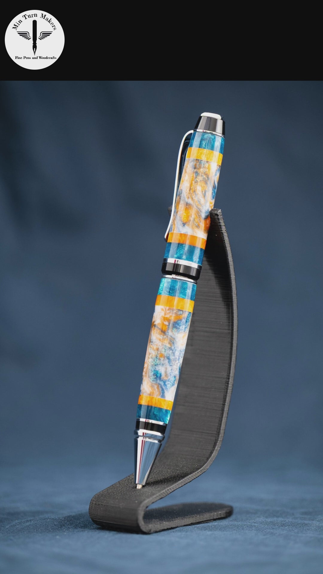 A handmade teal, orange, and white resin ballpoint Cigar pen with chrome plating.