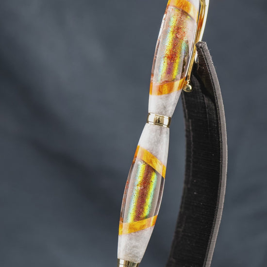 A short video highlighting the steps taken to create the custom red, gold, and white resin ballpoint pen.