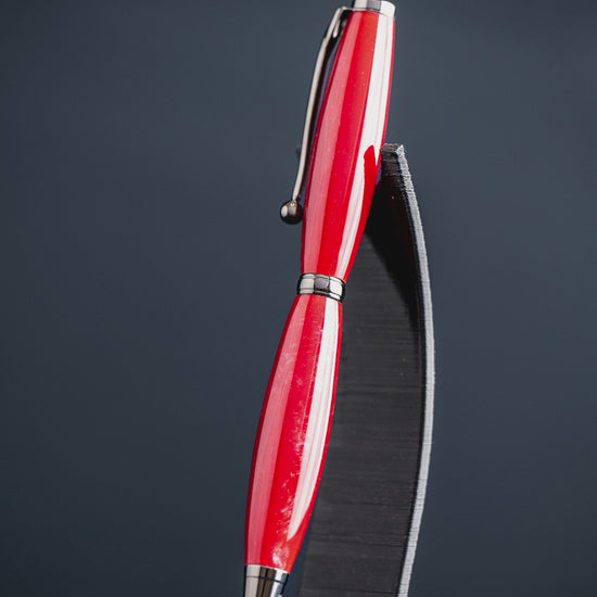 A video showing the steps taken to create a handmade red resin ballpoint twist pen