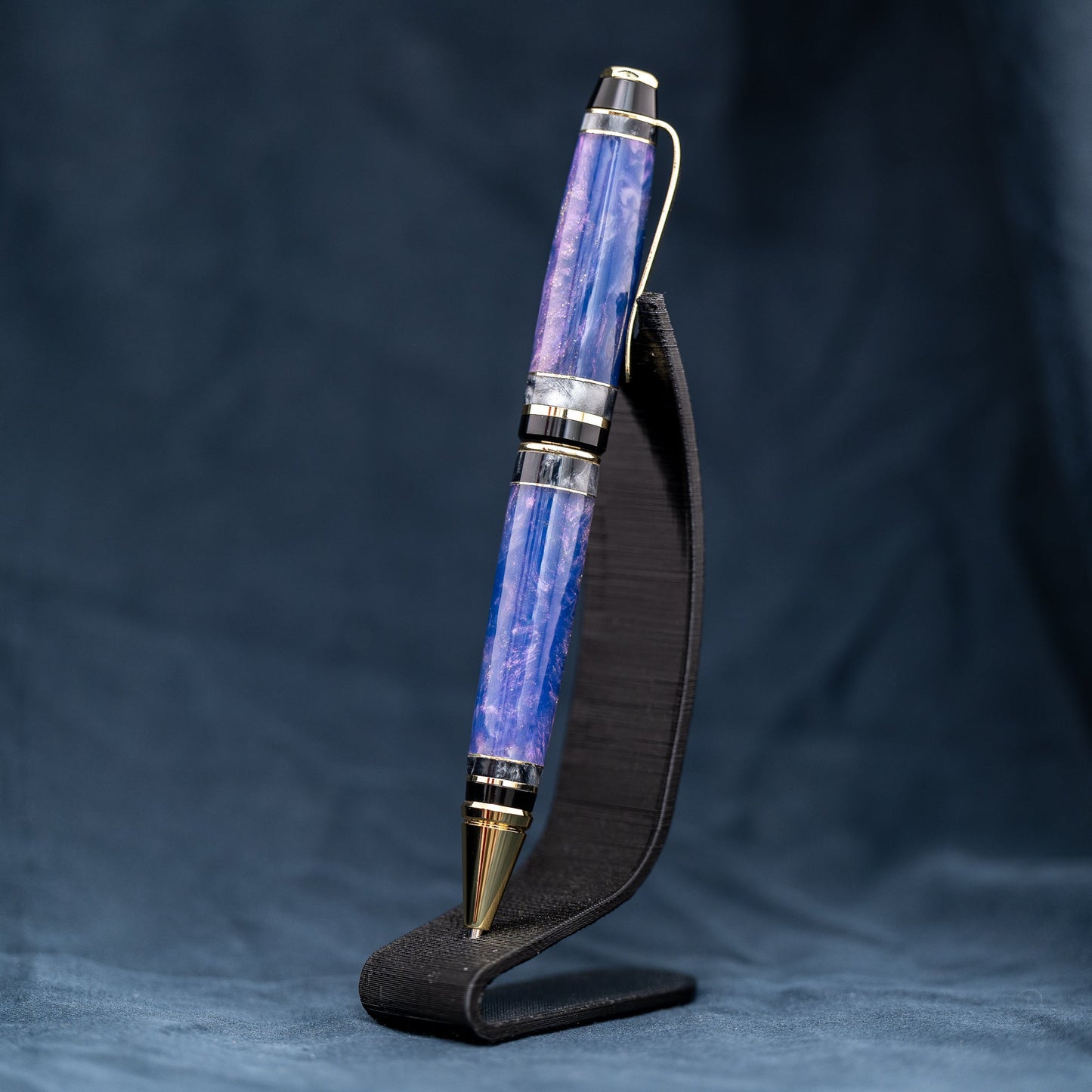 Handmade purple and grey resin ballpoint twist pen with brass veneer, gold plating, and black ink.