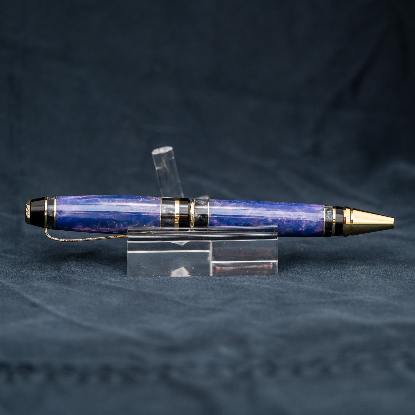 Handmade purple and grey resin ballpoint twist pen with brass veneer, gold plating, and black ink.