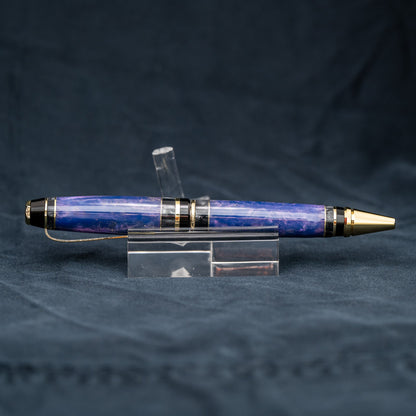 Handmade purple and grey resin ballpoint twist pen with brass veneer, gold plating, and black ink.