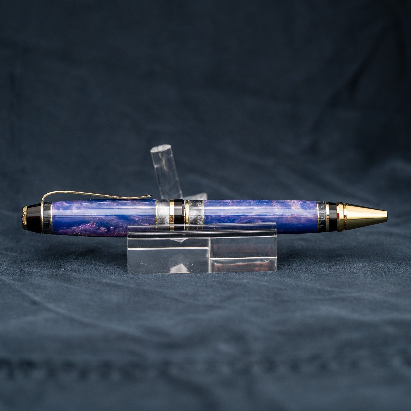 Handmade purple and grey resin ballpoint twist pen with brass veneer, gold plating, and black ink.