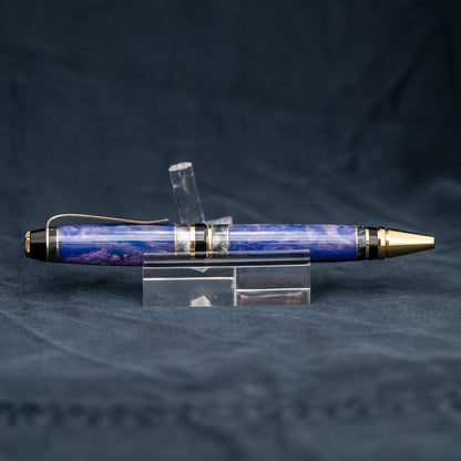 Handmade purple and grey resin ballpoint twist pen with brass veneer, gold plating, and black ink.