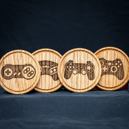 Four handmade Red Oak wood drink coasters with retro video game controller designs.