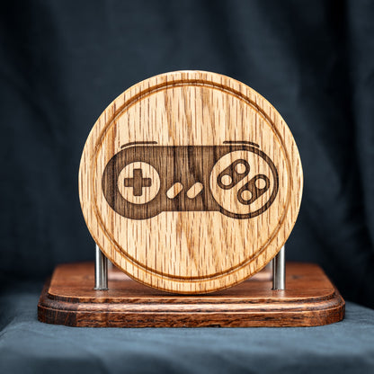 A handmade Red Oak wood drink coaster with Super Nintendo game controller design.