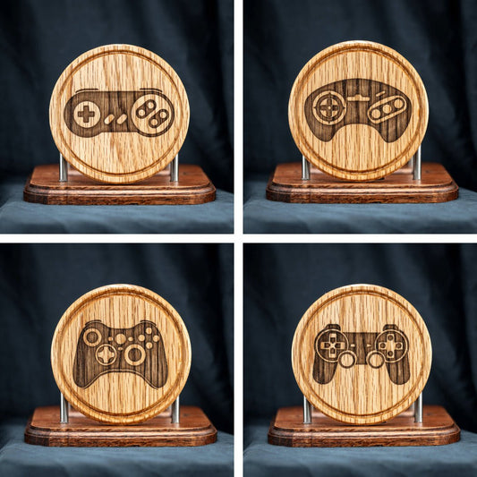 A set of four handmade red oak wooden drink coasters featuring retro video game controllers.