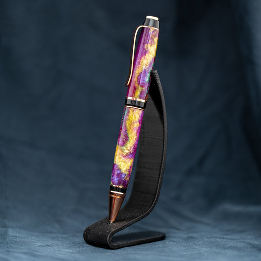 Handmade purple, green, and yellow resin twist ballpoint pen with bright copper plating and black ink.