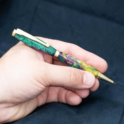 A handmade green, yellow, and purple resin ballpoint slimline twist pen with satin gold plating.