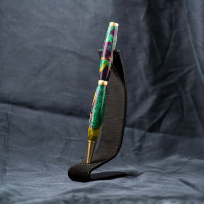 A handmade green, yellow, and purple resin ballpoint slimline twist pen with satin gold plating.