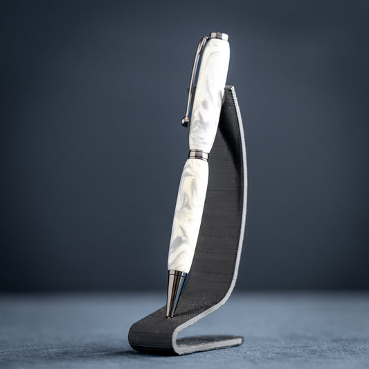 Pen with a white marble pattern on a black stand against a dark background