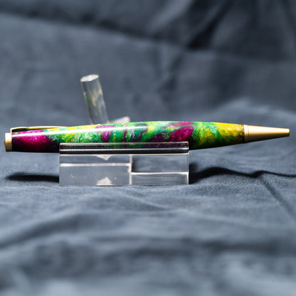 A handmade green, yellow, and purple resin ballpoint slimline twist pen with satin gold plating.