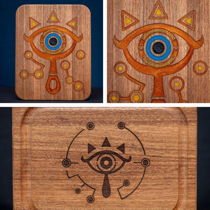 A handmade African Mahogany wooden cutting board featuring the Sheikah eye from the Legend of Zelda video games in resin inlay.