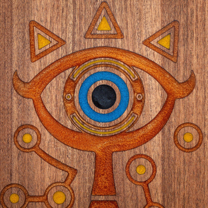 A handmade African Mahogany wooden cutting board featuring the Sheikah eye from the Legend of Zelda video games in resin inlay.