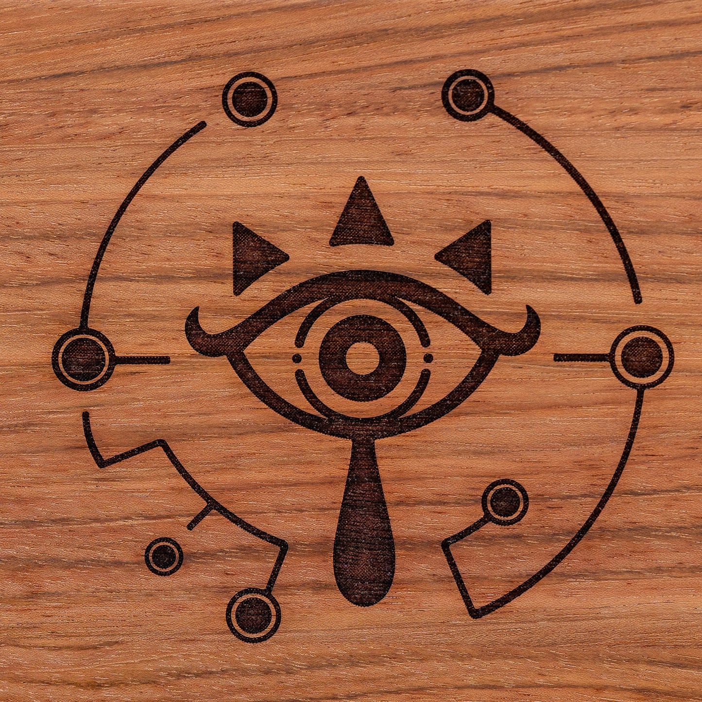 A handmade Jatoba wooden cutting board featuring the Sheikah eye from the Legend of Zelda video games in resin inlay.