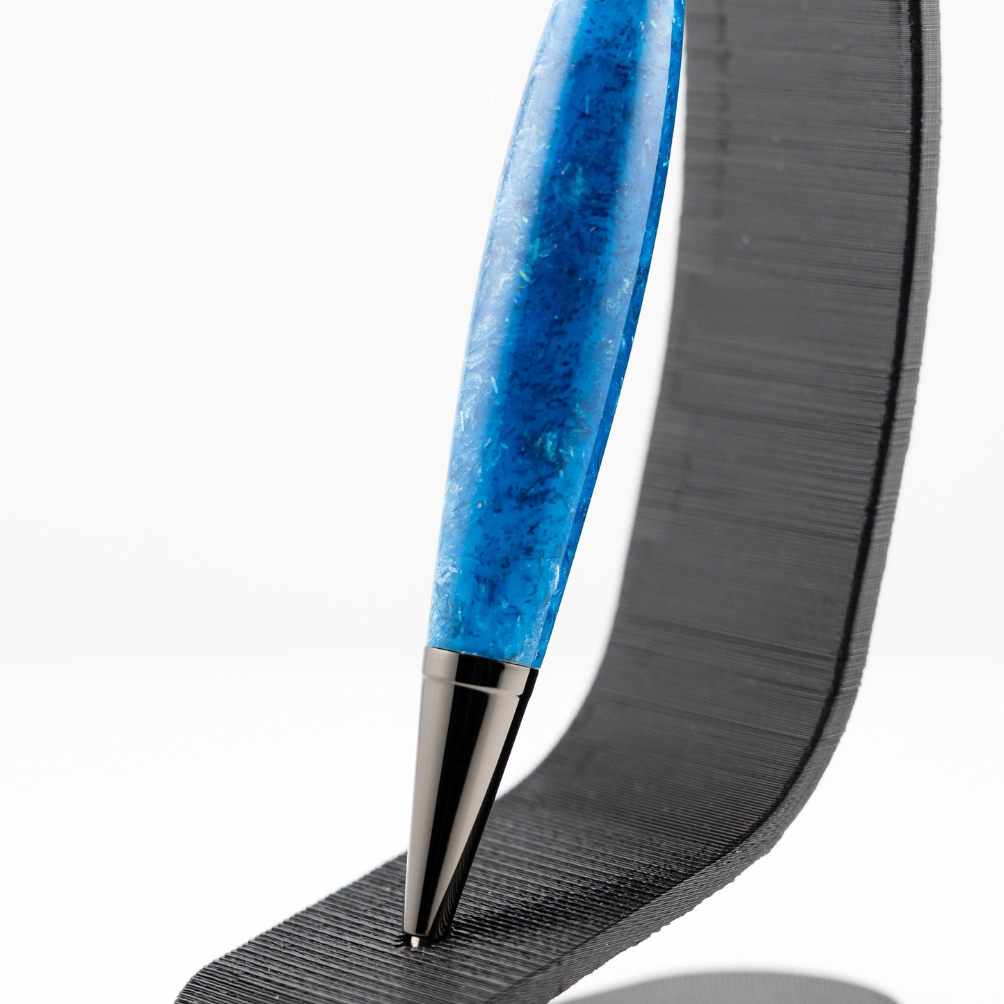 Handmade blue resin with blue sparkle effects in a slim lightweight ballpoint pen with gunmetal plating 