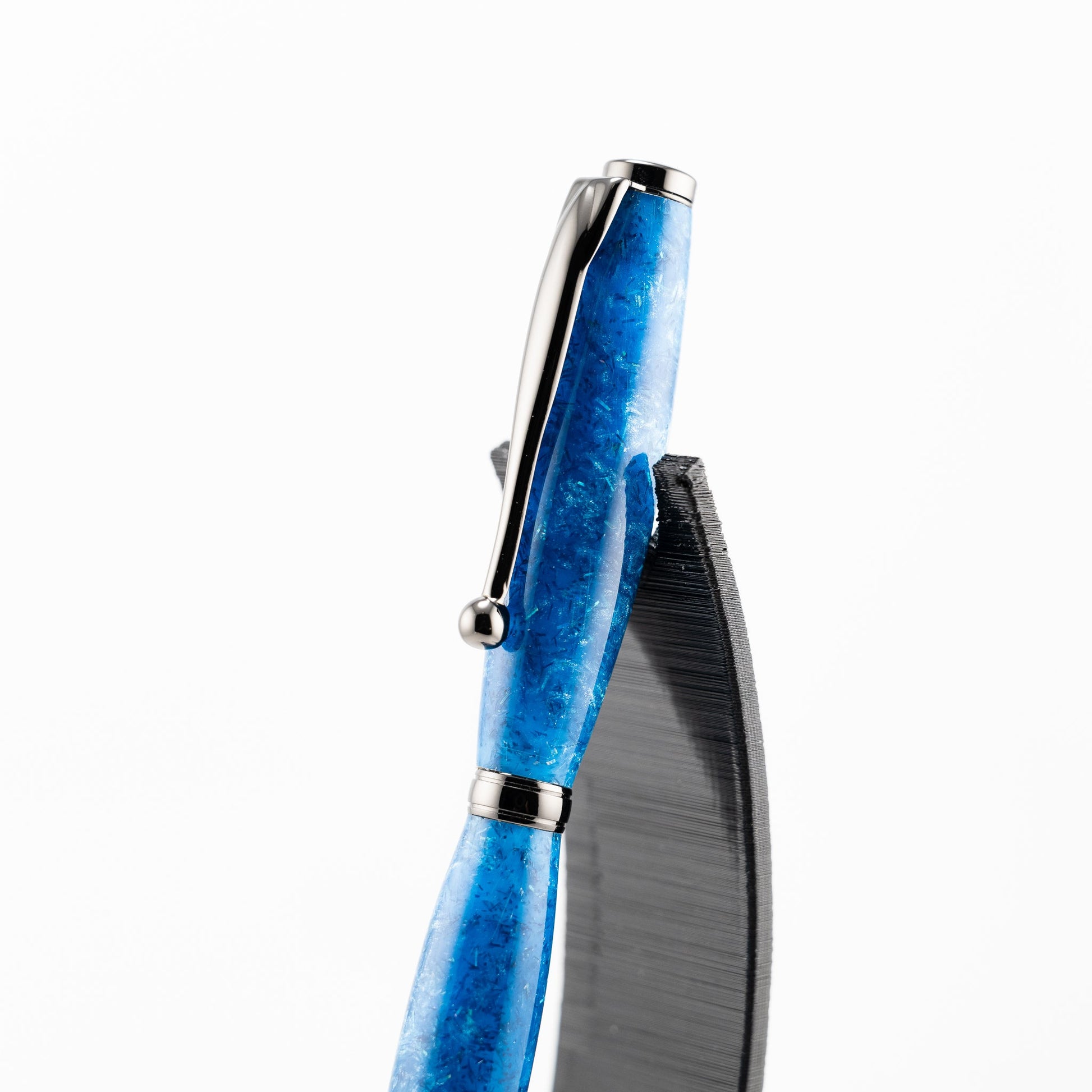 Handmade blue resin with blue sparkle effects in a slim lightweight ballpoint pen with gunmetal plating 