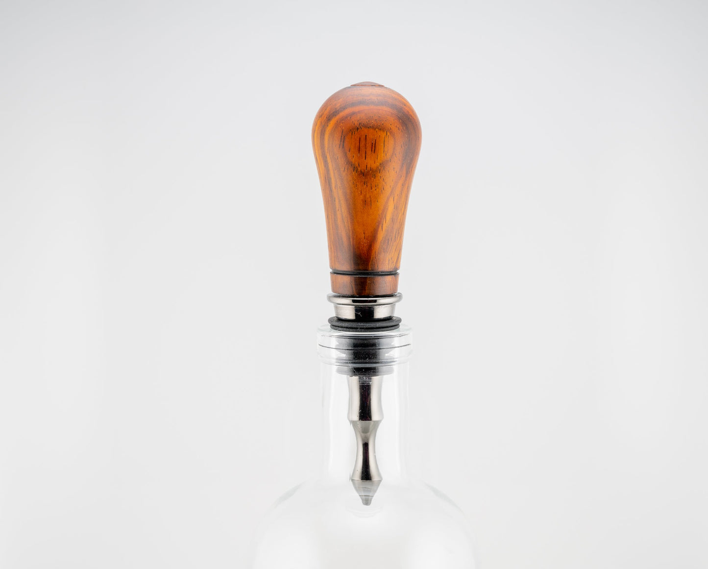 Handmade Cocobolo wood bottle stopper with single wood-burn line near the black titanium metal end