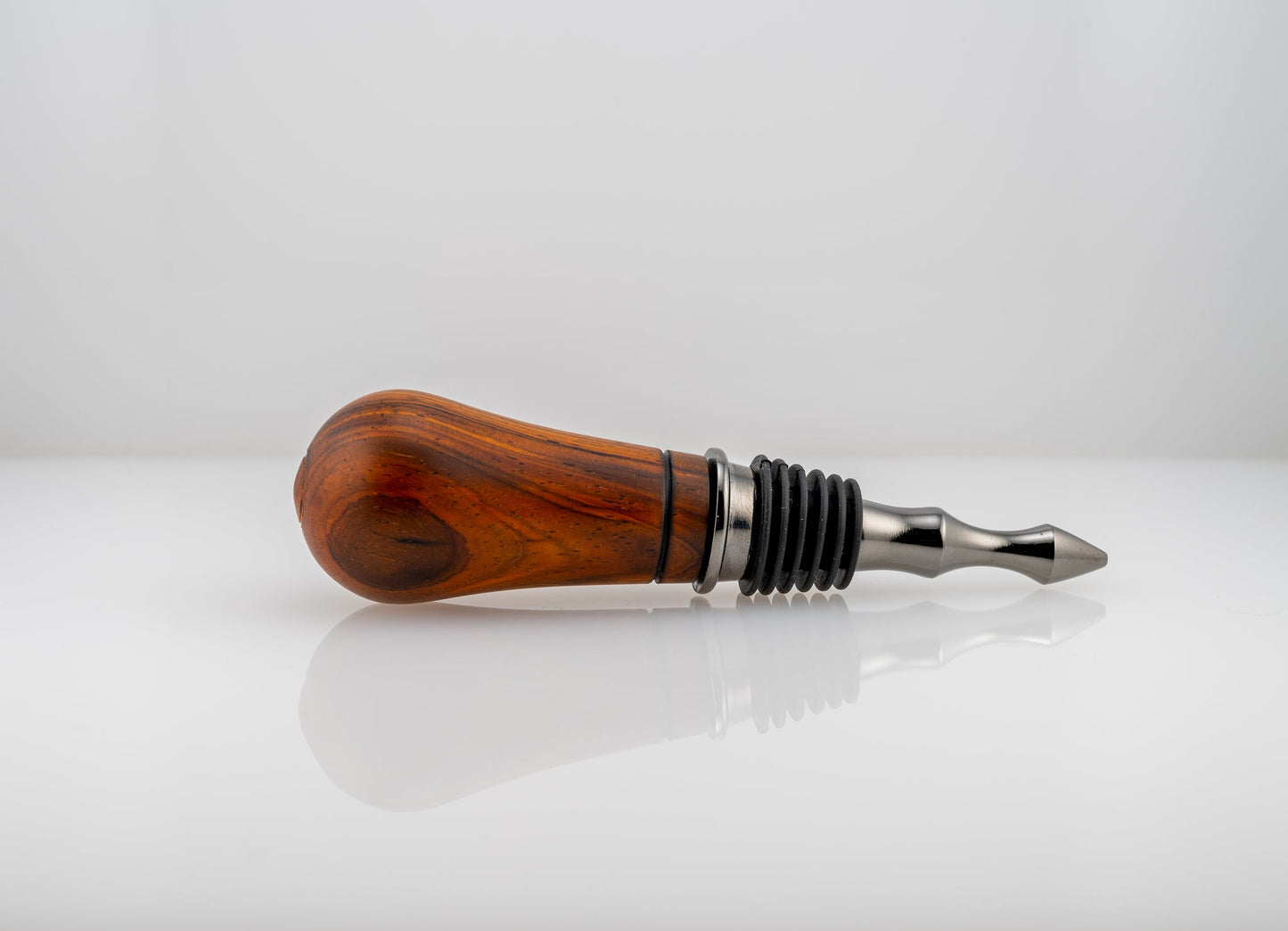 Handmade Cocobolo wood bottle stopper with single wood-burn line near the black titanium metal end