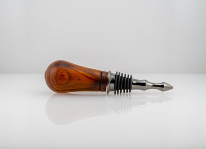 Handmade Cocobolo wood bottle stopper with single wood-burn line near the black titanium metal end
