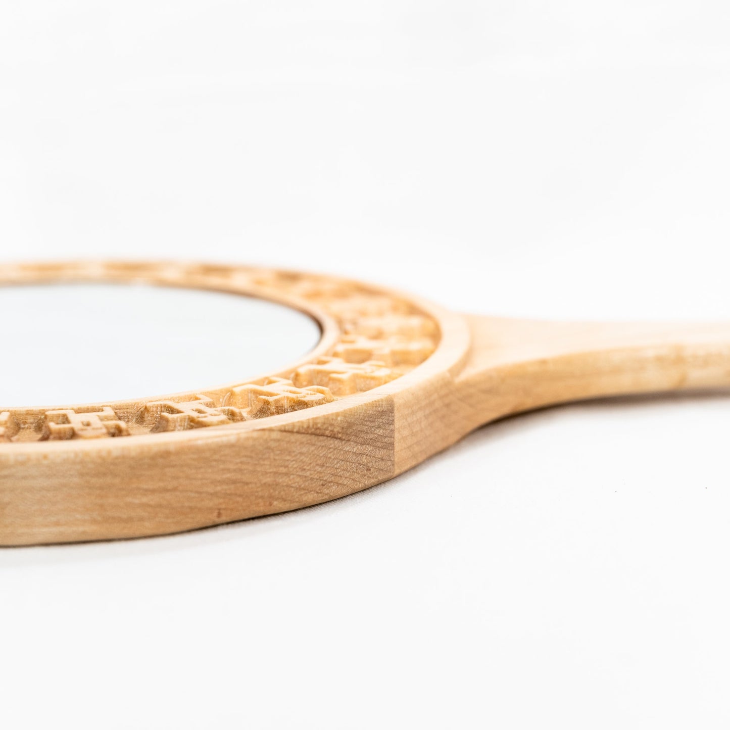 Handmade solid maple hand mirror with engraved cactuar characters around the glass and carved out meteor symbol on the back