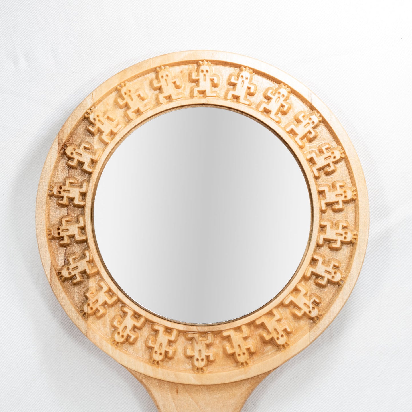 Handmade solid maple hand mirror with engraved cactuar characters around the glass and carved out meteor symbol on the back