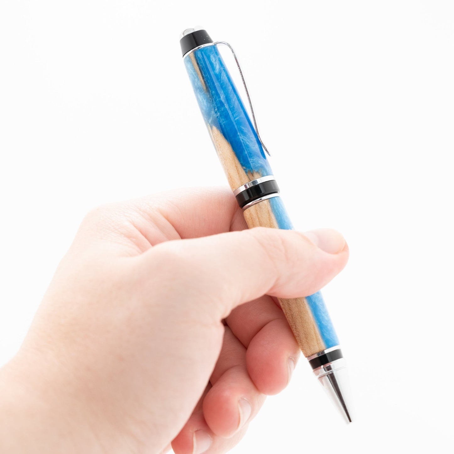 Handmade Maple wood suspended in blue sparkle resin twist pen in chrome plating
