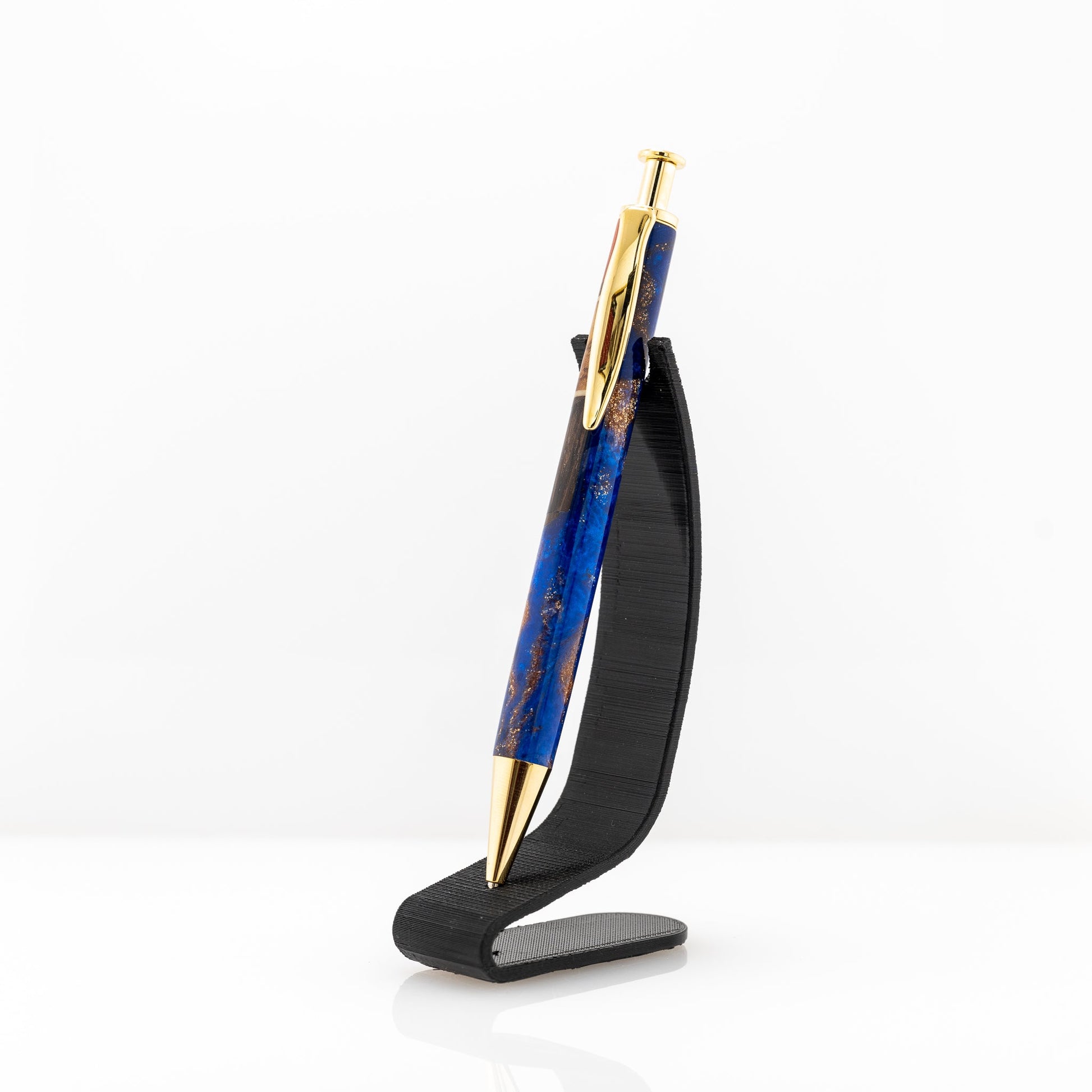 Handmade long click pen with olive wood, wenge, maple and redheart wood suspended in blue sparkle resin with gold plating