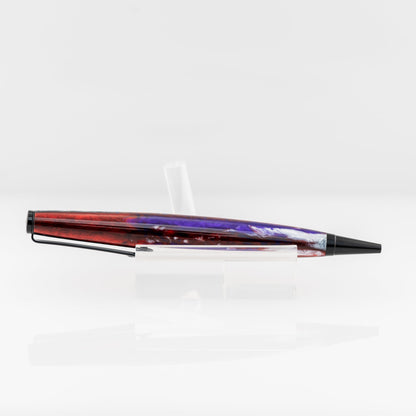 A handmade multicolored resin ballpoint pen with gold, blue, red, purple, and white