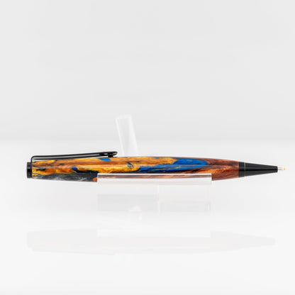 A handmade multicolored resin ballpoint pen with gold, blue, red, purple, and white