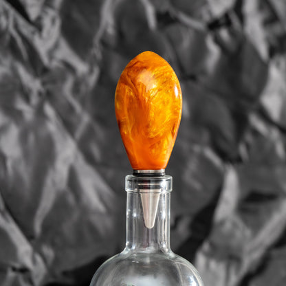 Handmade orange and gold resin swirl bottle stopper with a stainless steel dropper and silicon gaskets