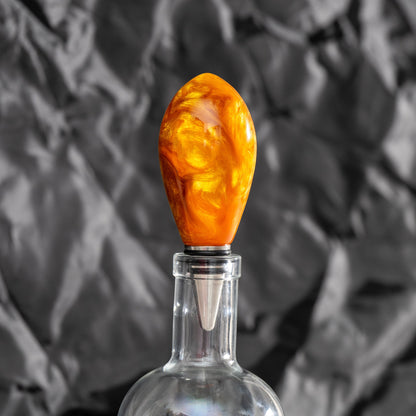 Handmade orange and gold resin swirl bottle stopper with a stainless steel dropper and silicon gaskets