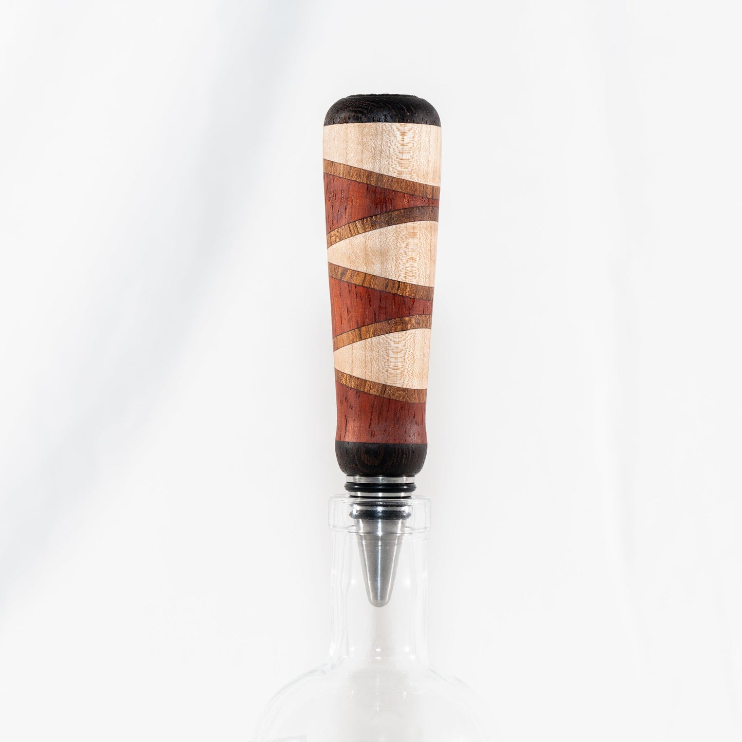 Handmade segmented wood bottle stopper of Padauk, Maple, Jatoba, and Wenge woods. Features a stainless steel dropper.