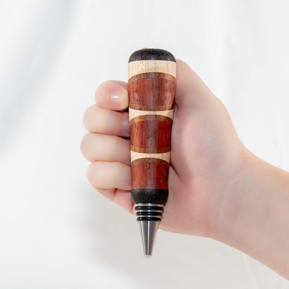 Handmade segmented wood bottle stopper of Padauk, Maple, Jatoba, and Wenge woods. Features a stainless steel dropper.
