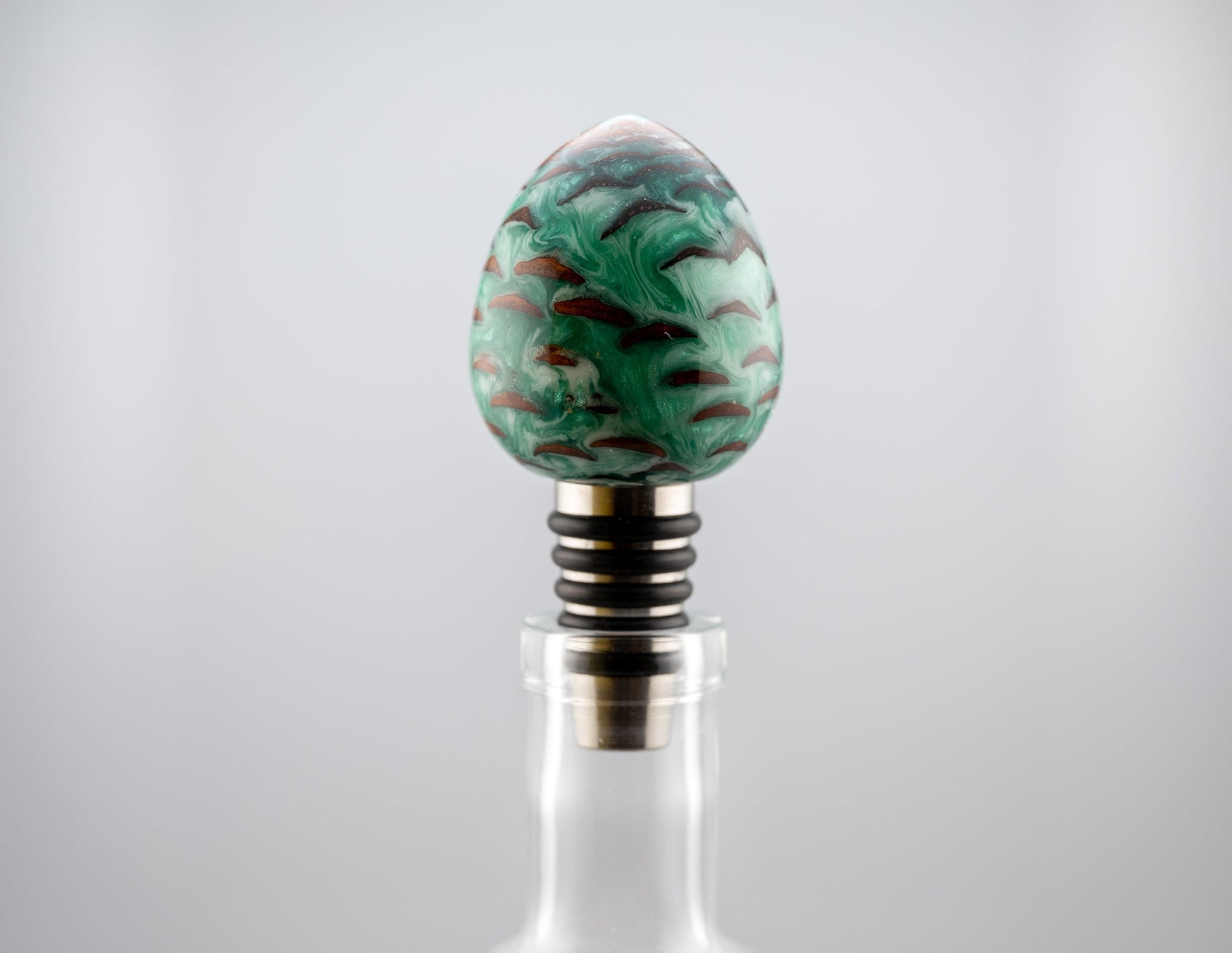 handmade pine cone and green and white resin bottle stopper