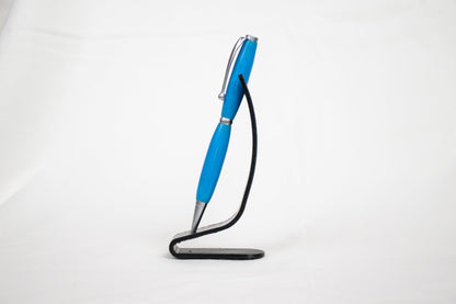 handmade blue resin twist ballpoint pen on a black stand