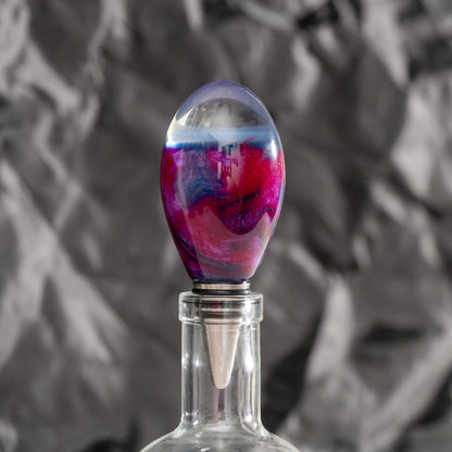 Handmade purple and red resin bottle stopper with a clear domed top, stainless steel dropper, and silicon gaskets