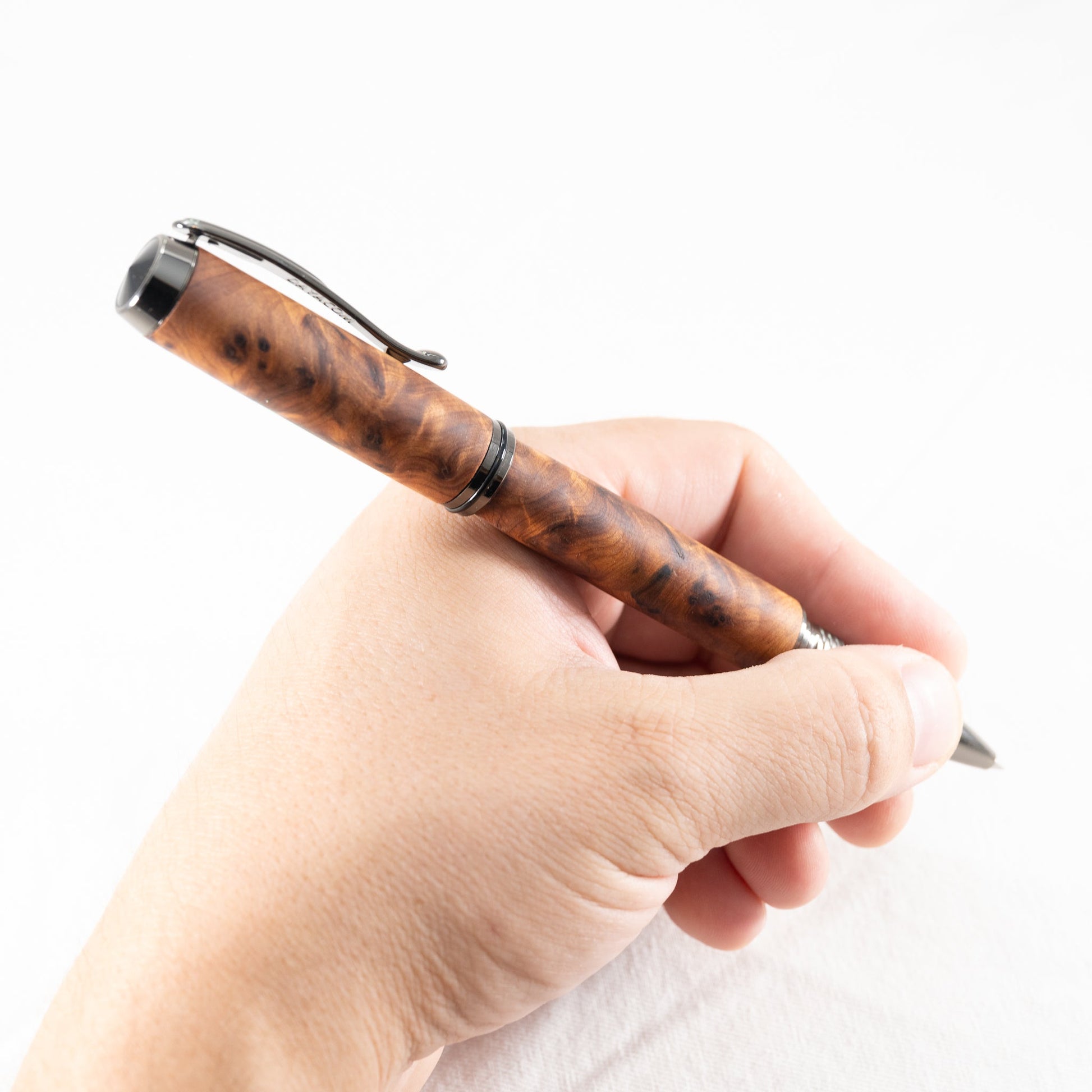 a handmade australian mallee burl rollerball pen with black titanium plating