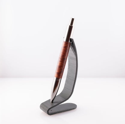 handmade burl wood vesper gun metal click pen on a black stand