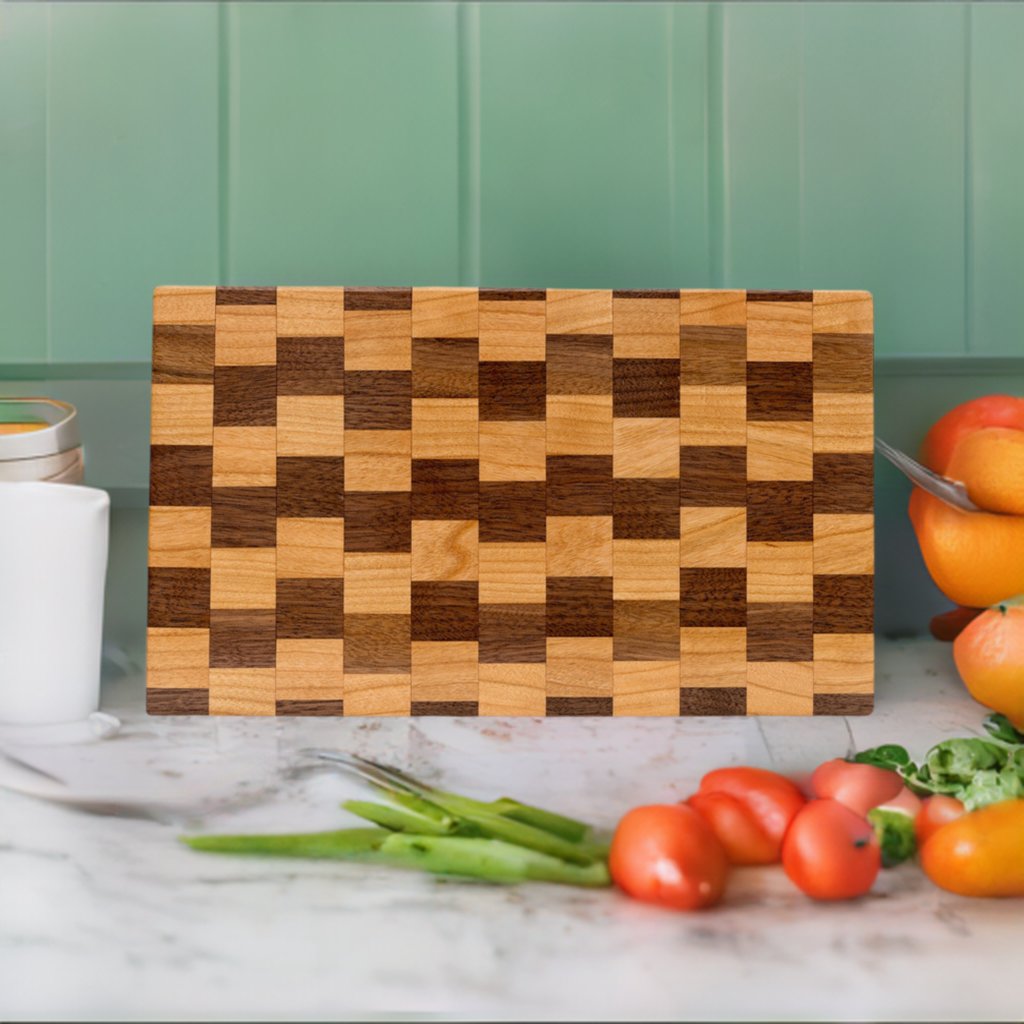 a wooden cutting board in front of green cabinets on a kitchen counter